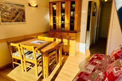 a kitchen with a wooden table and a cabinet at Bright apartment with views of Mont Blanc in Chamonix-Mont-Blanc