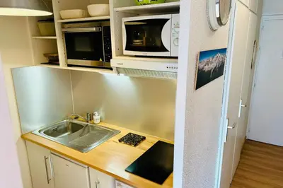 a small kitchen with a sink and microwave at Bright apartment with views of Mont Blanc in Chamonix-Mont-Blanc
