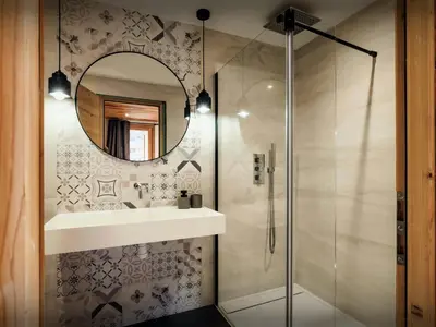 a bathroom with a sink and a mirror at Chalet Trumont - OVO Network in Samoëns