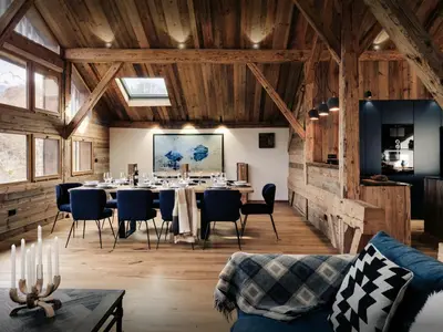 a dining room with a long table and chairs at Chalet Trumont - OVO Network in Samoëns