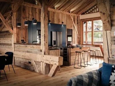 a large kitchen with wooden walls and wooden floors at Chalet Trumont - OVO Network in Samoëns
