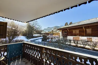 a balcony with a view of a snow covered yard at Cozy apartment in Saint-Gervais-les-Bains in Saint-Gervais-les-Bains