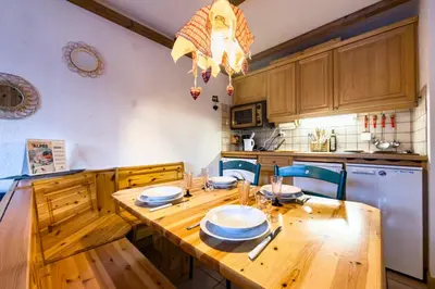 a kitchen with a wooden table with plates on it at Cozy apartment in Saint-Gervais-les-Bains in Saint-Gervais-les-Bains