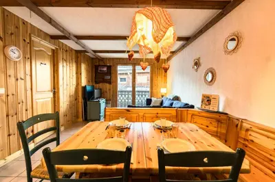 a dining room with a wooden table and chairs at Cozy apartment in Saint-Gervais-les-Bains in Saint-Gervais-les-Bains