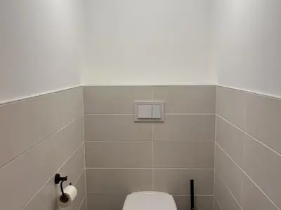 a bathroom with a toilet and a toilet paper dispenser at Duplex neuf 78m², 2 chambres, poêle, WIFI, parking, pour 5 pers. - Arâches-la-Frasse - FR-1-836-57 in Arâches-la-Frasse