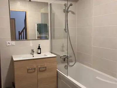 a bathroom with a sink and a shower at Duplex neuf 78m², 2 chambres, poêle, WIFI, parking, pour 5 pers. - Arâches-la-Frasse - FR-1-836-57 in Arâches-la-Frasse