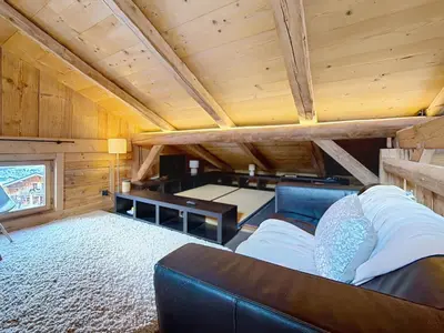 a bedroom with a bed and a wooden wall at Chalet 5 chambres + dortoir proche pistes Combloux - FR-1-560-173 in Combloux