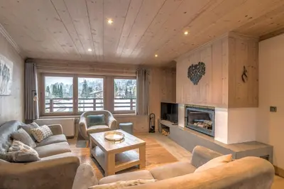 a living room with couches and a fireplace at Appartement Pravy - Welkeys in Megève