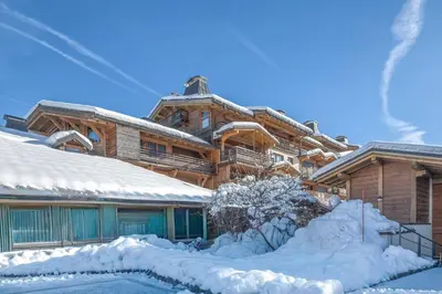 a log cabin in the snow with a pool at Appartement Pravy - Welkeys in Megève