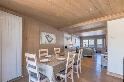 a dining room with a table and chairs at Appartement Pravy - Welkeys in Megève