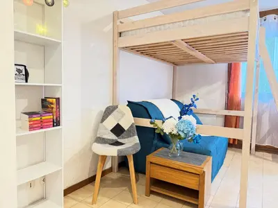 a living room with a bunk bed and a chair at L'Orée du Parc in Saint-Gervais-les-Bains