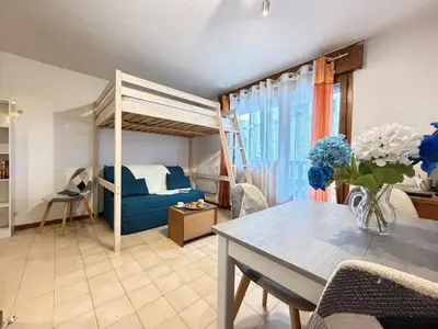 a living room with a bunk bed and a table at L'Orée du Parc in Saint-Gervais-les-Bains