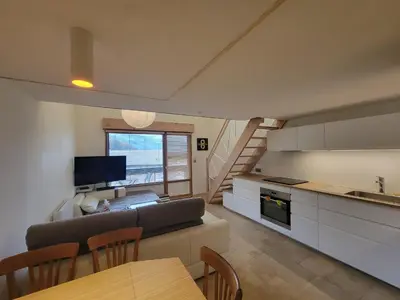 a kitchen and living room with a couch and a table at Lechappee Valleenne in Saint-Gervais-les-Bains