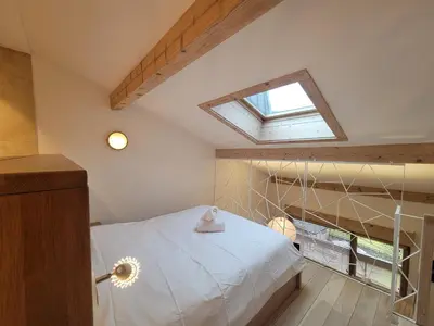a bedroom with a white bed and a window at Lechappee Valleenne in Saint-Gervais-les-Bains