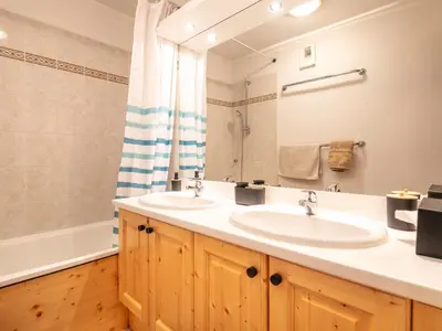 a bathroom with two sinks and a mirror at Gelinotte N51 4P6 in Morillon
