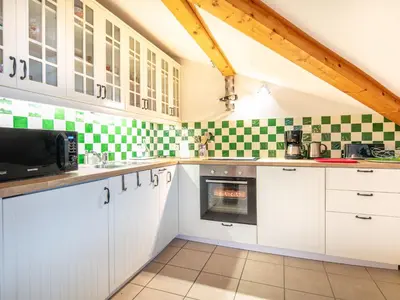 a kitchen with green and white tiles on the wall at Gelinotte N51 4P6 in Morillon