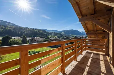 a view from the balcony of a cabin with a view at Chalet Les Sapins - Megève in Megève