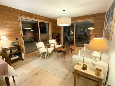 a living room with a couch and chairs and a table at Apartment With Nordic Bath In Les Carroz in Les Carroz d'Araches