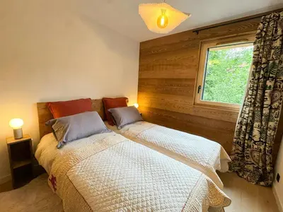 a wooden deck with a table and a snow covered field at Apartment With Nordic Bath In Les Carroz in Les Carroz d'Araches