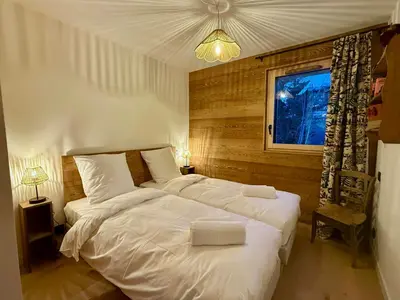 a living room with a table and a living room with a couch at Apartment With Nordic Bath In Les Carroz in Les Carroz d'Araches