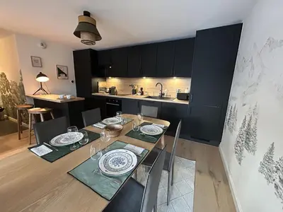 a dining room and kitchen with a table and chairs at Appartement de standing 2 chambres, Wi-Fi, animaux admis, parking - FR-1-836-56 in Arâches-la-Frasse