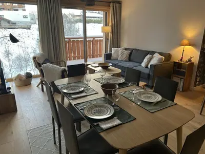 a living room with a table and a couch at Appartement de standing 2 chambres, Wi-Fi, animaux admis, parking - FR-1-836-56 in Arâches-la-Frasse