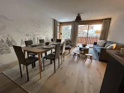 a living room with a table and chairs and a couch at Appartement de standing 2 chambres, Wi-Fi, animaux admis, parking - FR-1-836-56 in Arâches-la-Frasse
