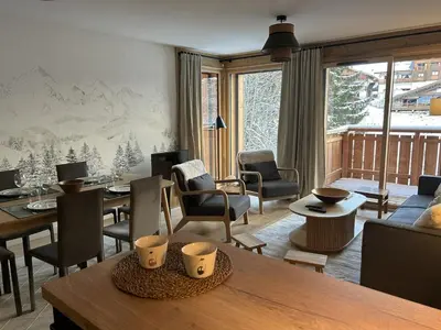 a living room with a table and chairs at Appartement de standing 2 chambres, Wi-Fi, animaux admis, parking - FR-1-836-56 in Arâches-la-Frasse