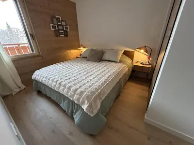 a small bedroom with a bed and a window at Appartement de standing 2 chambres, Wi-Fi, animaux admis, parking - FR-1-836-56 in Arâches-la-Frasse
