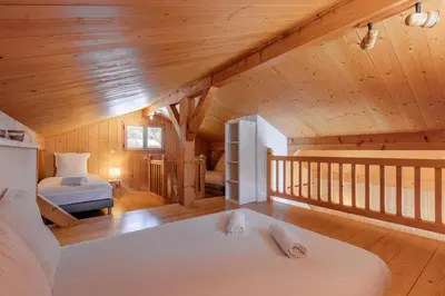 a bedroom in a log cabin with two beds at Chalet de Nina in Les Houches