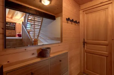 a wooden cabin with a mirror and a door at Chalet de Nina in Les Houches