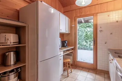 a white refrigerator in a kitchen with a window at Chalet de Nina in Les Houches
