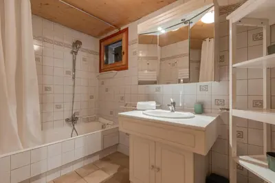 a bathroom with a sink and a shower and a tub at Chalet de Nina in Les Houches