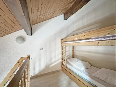 a bedroom with two bunk beds and a staircase at NAN116 - Duplex 4-6 pers face a la telecabine in Les Carroz d'Araches