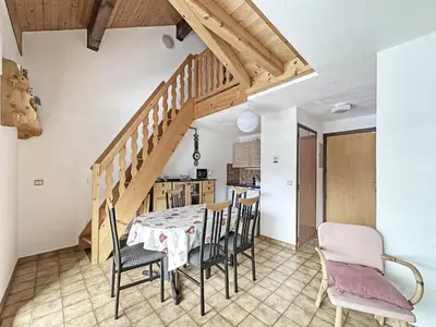 a kitchen and dining room with a table and chairs at NAN116 - Duplex 4-6 pers face a la telecabine in Les Carroz d'Araches
