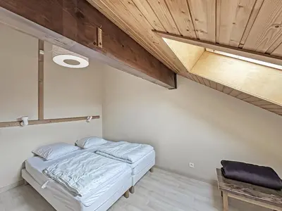 a bedroom with a bed and a wooden ceiling at NAN116 - Duplex 4-6 pers face a la telecabine in Les Carroz d'Araches