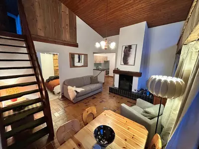 a living room with a couch and a table at Chalet des Cinq in Samoëns