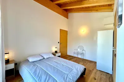 a bedroom with a bed and a wooden ceiling at Comfortable stay 200m from the ski lifts in Combloux