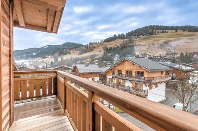 a view from the balcony of a log cabin at Appartement Jorat - Welkeys in Megève