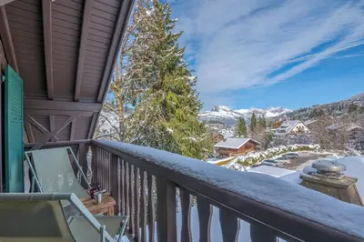 a balcony with a view of the mountains at Appartement La musardière - Welkeys in Megève