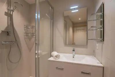 a bathroom with a sink and a shower at Appartement La musardière - Welkeys in Megève