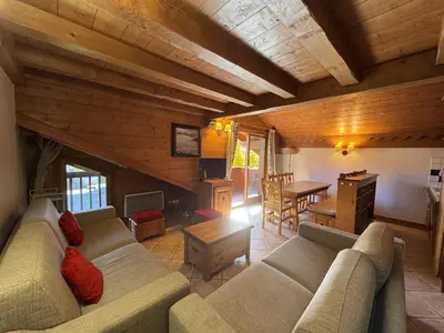 a living room with a couch and a table at Appartement 5 pièces - Piscine et Spa, Capacité 8 pers. - FR-1-836-60 in Arâches-la-Frasse