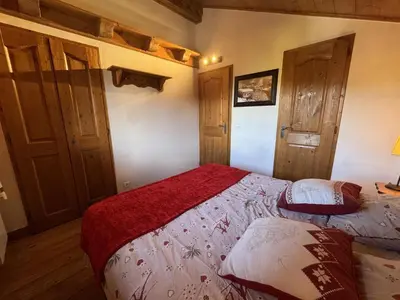 a bedroom with a bed with a red blanket at Appartement 5 pièces - Piscine et Spa, Capacité 8 pers. - FR-1-836-60 in Arâches-la-Frasse