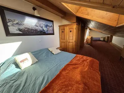 a bedroom with a bed with a large painting on the wall at Appartement 5 pièces - Piscine et Spa, Capacité 8 pers. - FR-1-836-60 in Arâches-la-Frasse