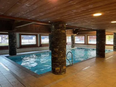 a swimming pool in a building with a wooden ceiling at Appartement 5 pièces - Piscine et Spa, Capacité 8 pers. - FR-1-836-60 in Arâches-la-Frasse