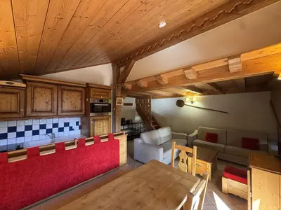 a kitchen and living room with a table and a couch at Appartement 5 pièces - Piscine et Spa, Capacité 8 pers. - FR-1-836-60 in Arâches-la-Frasse