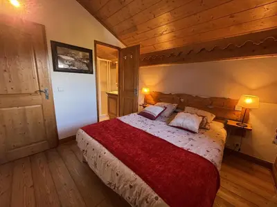 a bedroom with a large bed with a red blanket at Appartement 5 pièces - Piscine et Spa, Capacité 8 pers. - FR-1-836-60 in Arâches-la-Frasse