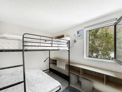 a bedroom with two bunk beds and a window at OEI30 - 3 pieces 6 pers proche centre station in Les Carroz d'Araches