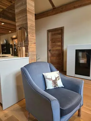 a blue chair with a pillow in a kitchen at Les Clarines des Contamines in Les Contamines-Montjoie