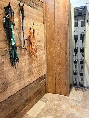 a room with a wooden wall with skis on it at Les Clarines des Contamines in Les Contamines-Montjoie